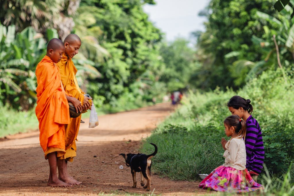 Cambodian Mom and Daughter Offer Alm to Monk on Their Morning Rounds