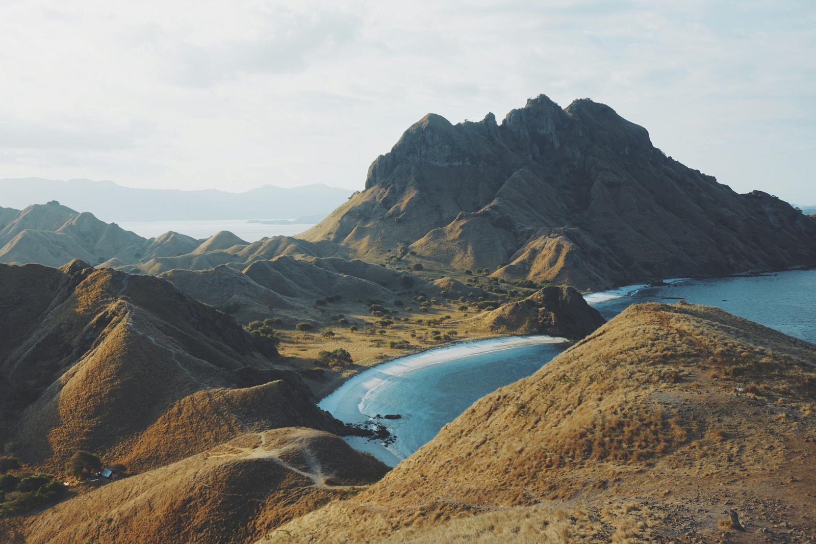 A breathtaking aerial shot of Padar Island's rugged landscape and serene beaches in Indonesia.