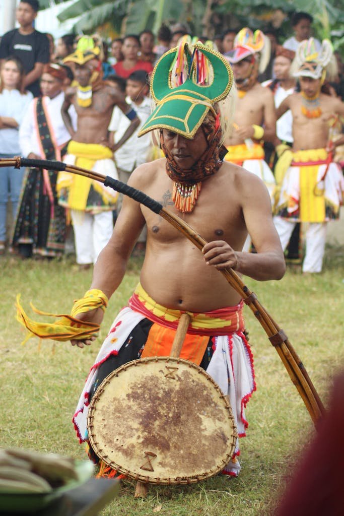A man in cultural attire performs the traditional Caci dance in Badjo, Indonesia.
