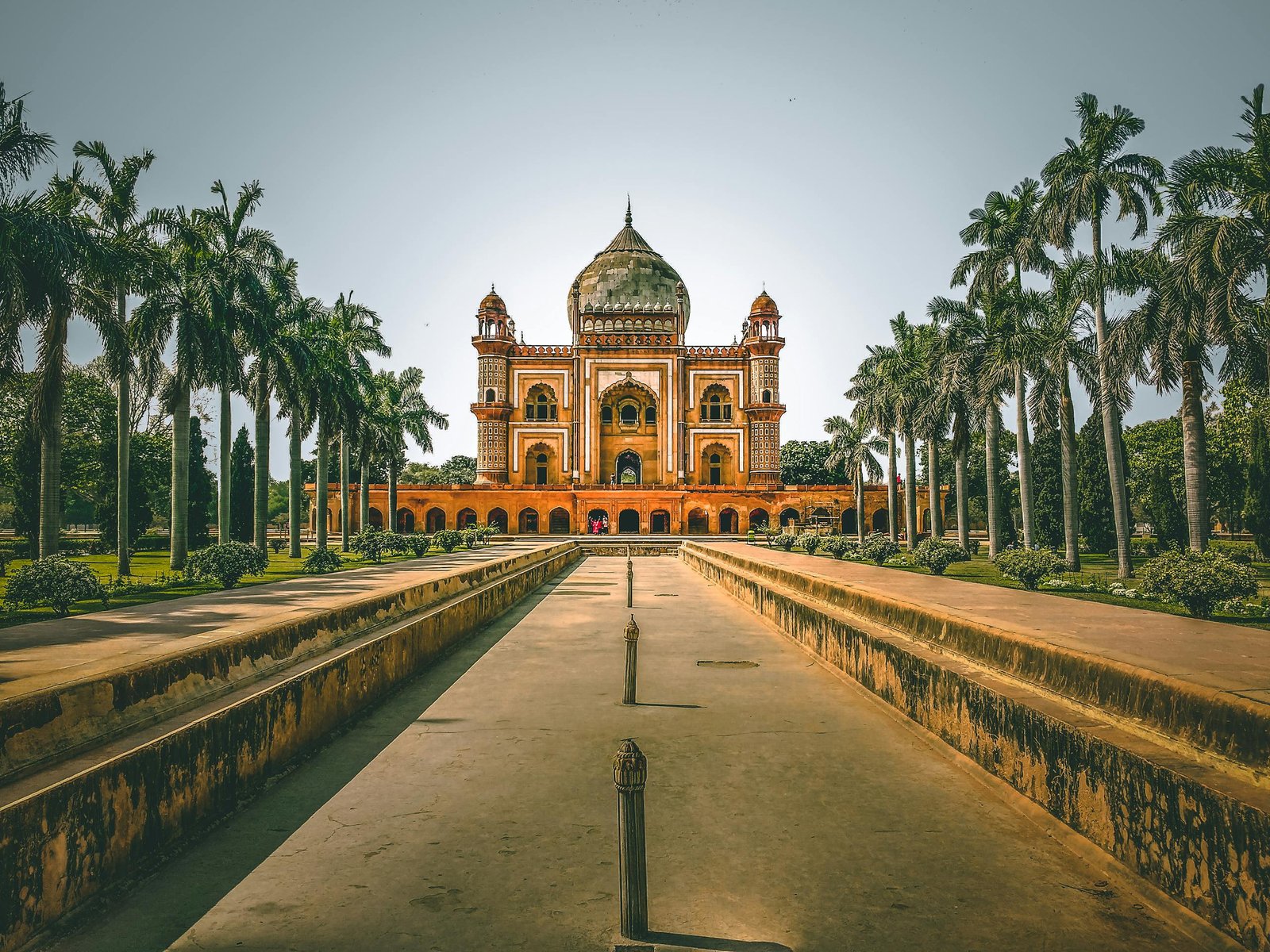 Explore the stunning Safdarjung Tomb in New Delhi, India, surrounded by lush gardens and palm trees.