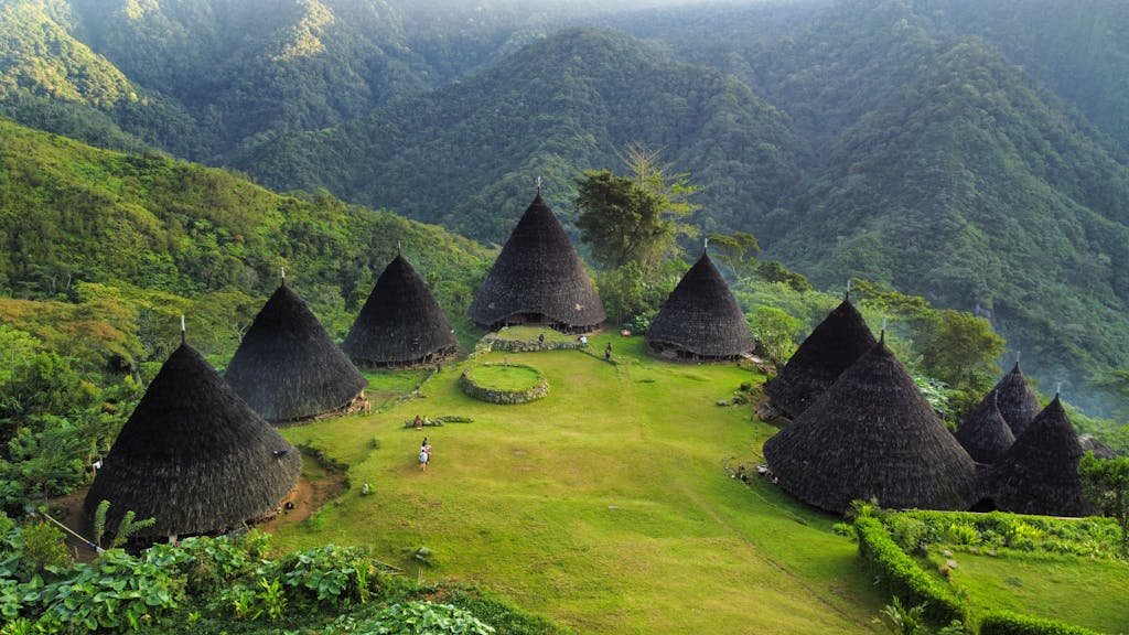 Explore the stunning Wae Rebo Village in Indonesia, nestled in lush mountains.