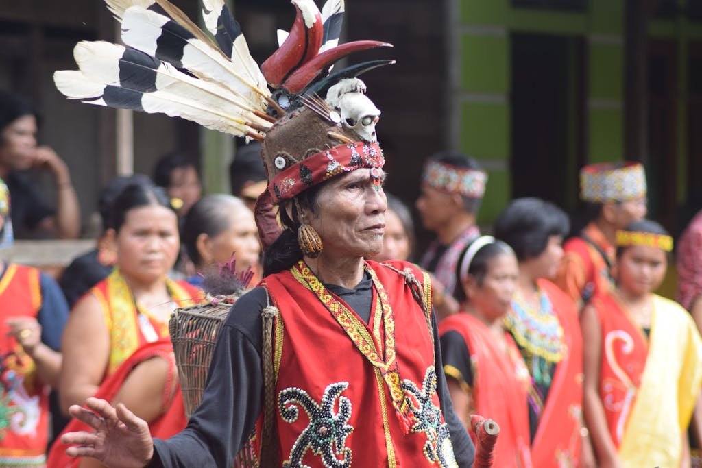Vibrant celebration of Dayak culture with traditional costumes and rituals in Kalimantan Barat, Indonesia.